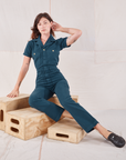 Alex is wearing Heritage Short Sleeve Jumpsuit in Lagoon