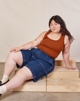 Ashley is wearing Carpenter Shorts in Dark Wash and burnt terracotta Cropped Tank
