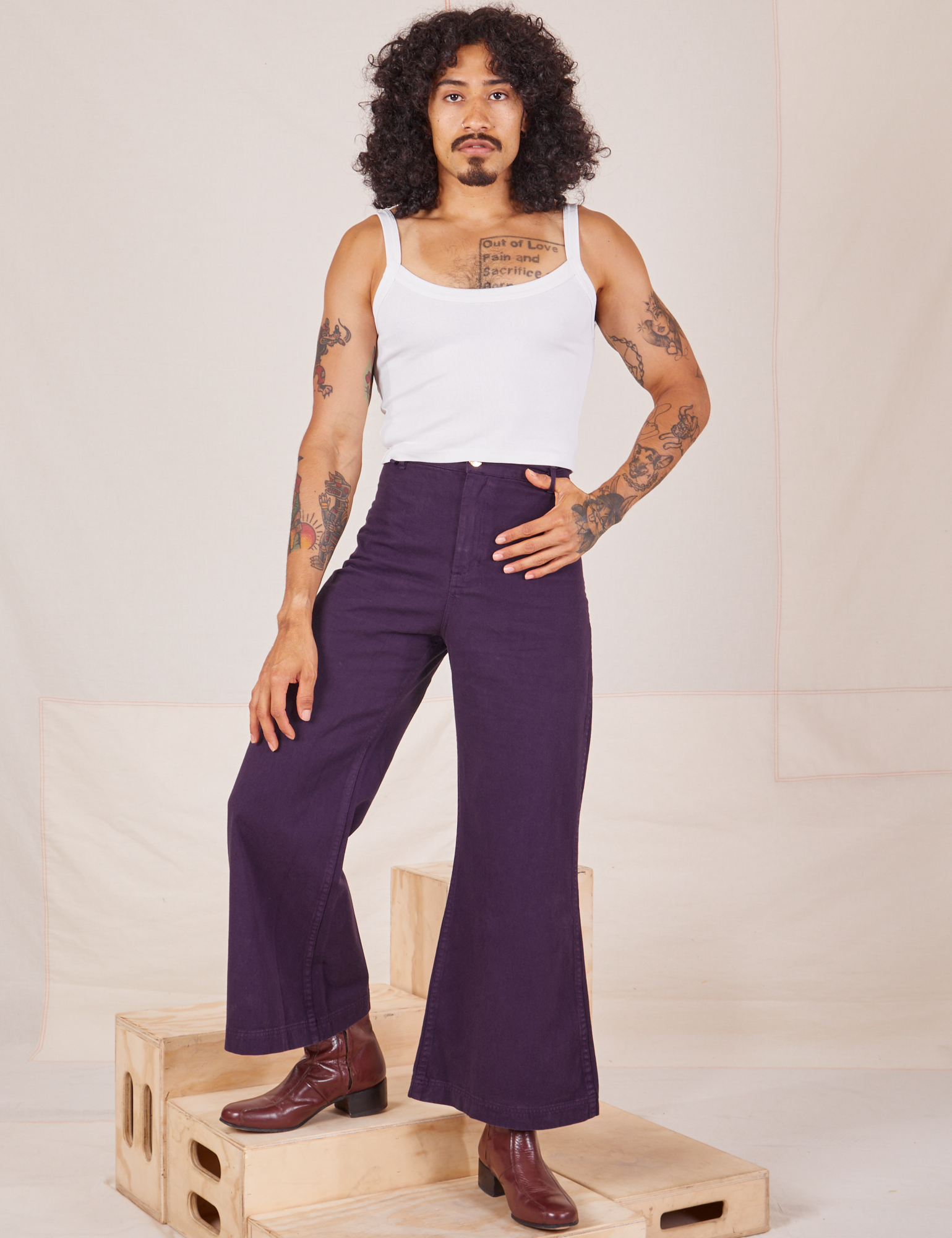 Jesse is 5&#39;8&quot; and wearing XXS Bell Bottoms in Nebula Purple paired with Cropped Cami in vintage tee off-white