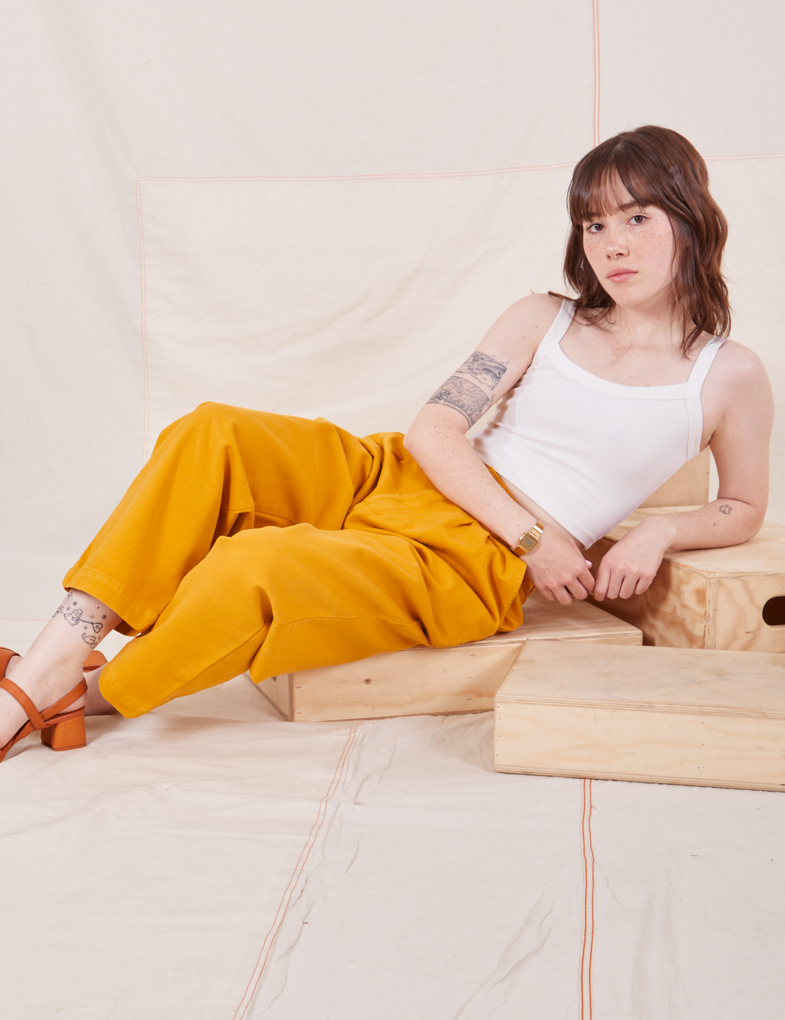 Hana is wearing Organic Trousers in Mustard Yellow and Cropped Cami in vintage tee off-white