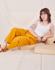 Hana is wearing Organic Trousers in Mustard Yellow and Cropped Cami in vintage tee off-white