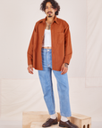 Jesse is wearing Oversize Overshirt in Burnt Terracotta paired with vintage off-white Tank Top and light wash Frontier Jeans