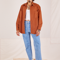 Jesse is wearing Oversize Overshirt in Burnt Terracotta paired with vintage off-white Tank Top and light wash Frontier Jeans