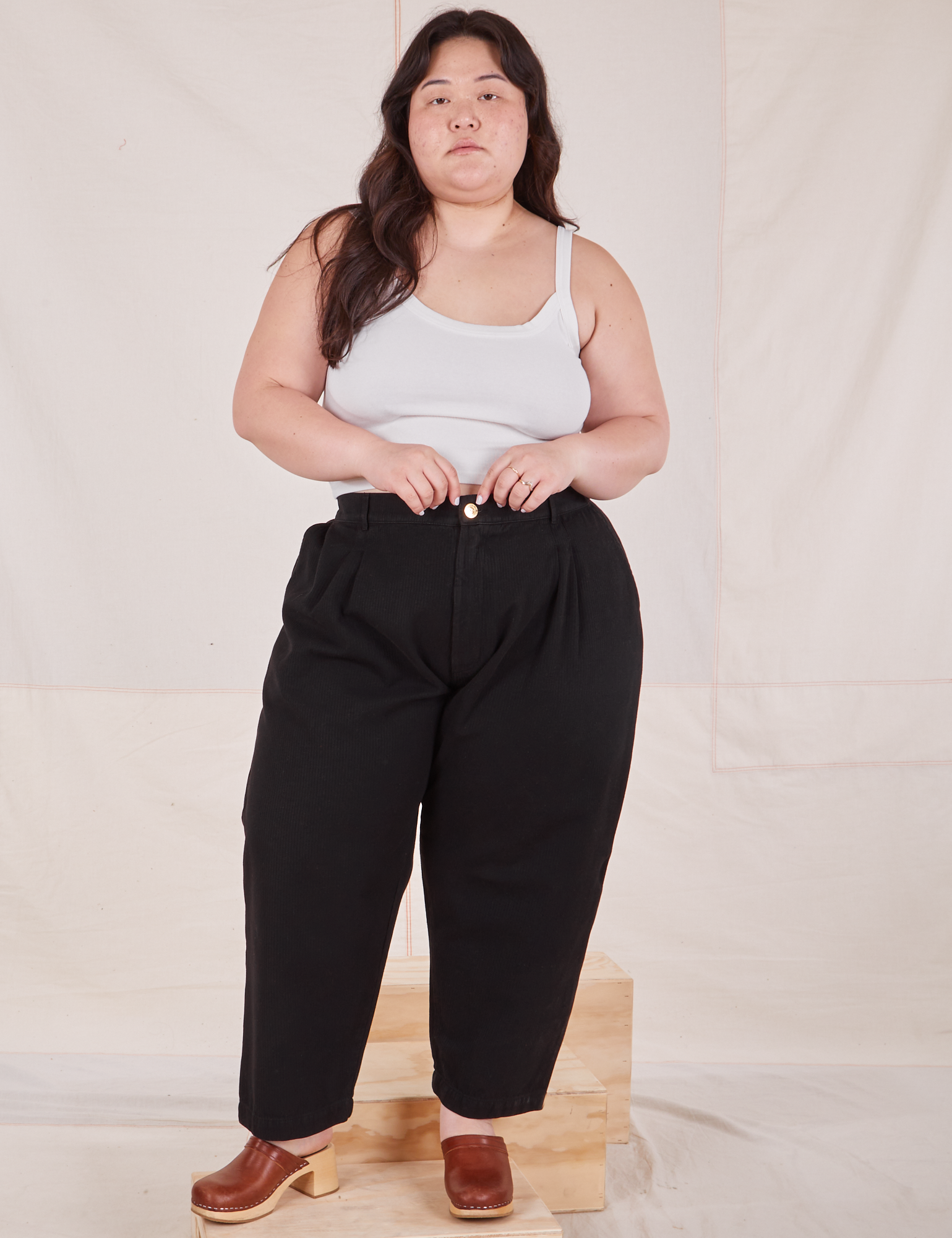 Ashley is 5'7" and wearing 1XL Petite Heritage Trousers in Basic Black