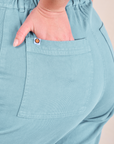 Short Sleeve Jumpsuit in Baby Blue back pocket close up. Lish has her hand in the pocket.
