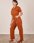 Side view of Short Sleeve Jumpsuit in Burnt Terracotta worn by Tiara