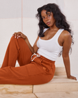 Kandia is wearing Rolled Cuff Sweat Pants in Burnt Terracotta and vintage off-white Cropped Tank