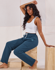 Kandia is wearing Rolled Cuff Sweat Pants in Lagoon and vintage off-white Cropped Tank