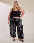 Juliet is 5'7" and wearing 1XL Magic Waters Drop Pocket Pants in Ink Blot paired with a black Cropped Tank
