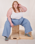 Catie is wearing Indigo Wide Leg Trousers in Light Wash and vintage off-white Cami