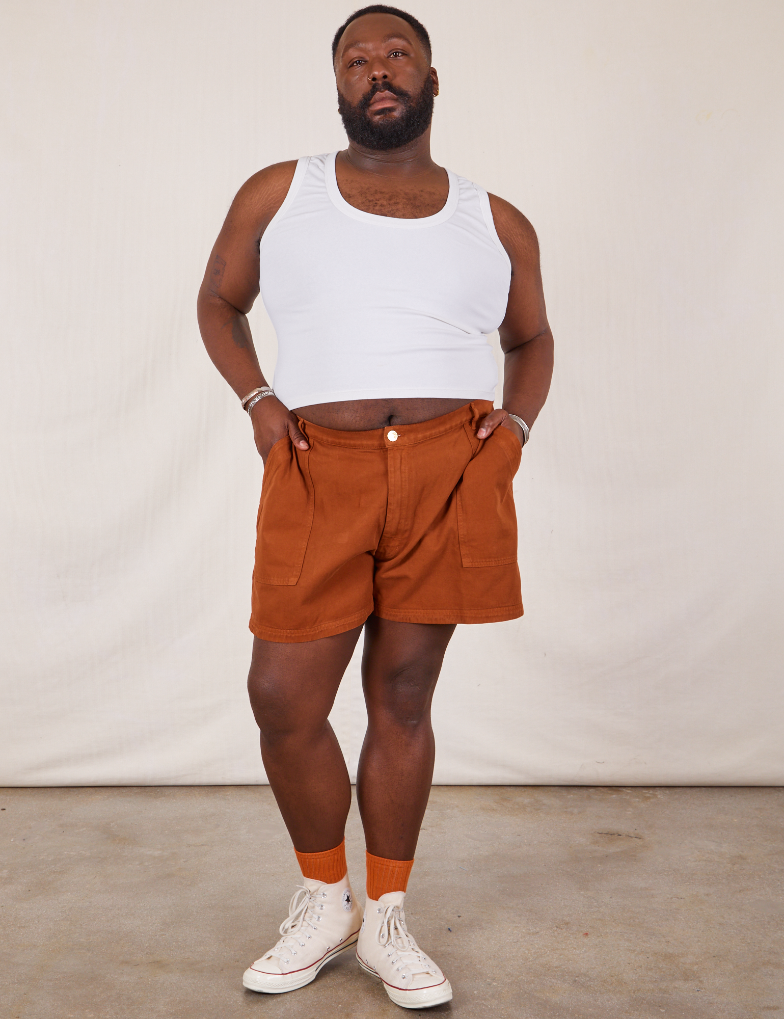 Elijah is 6’0” and wearing 3XL Classic Work Shorts in Burnt Terracotta paired with Cropped Tank Top in vintage tee off-white