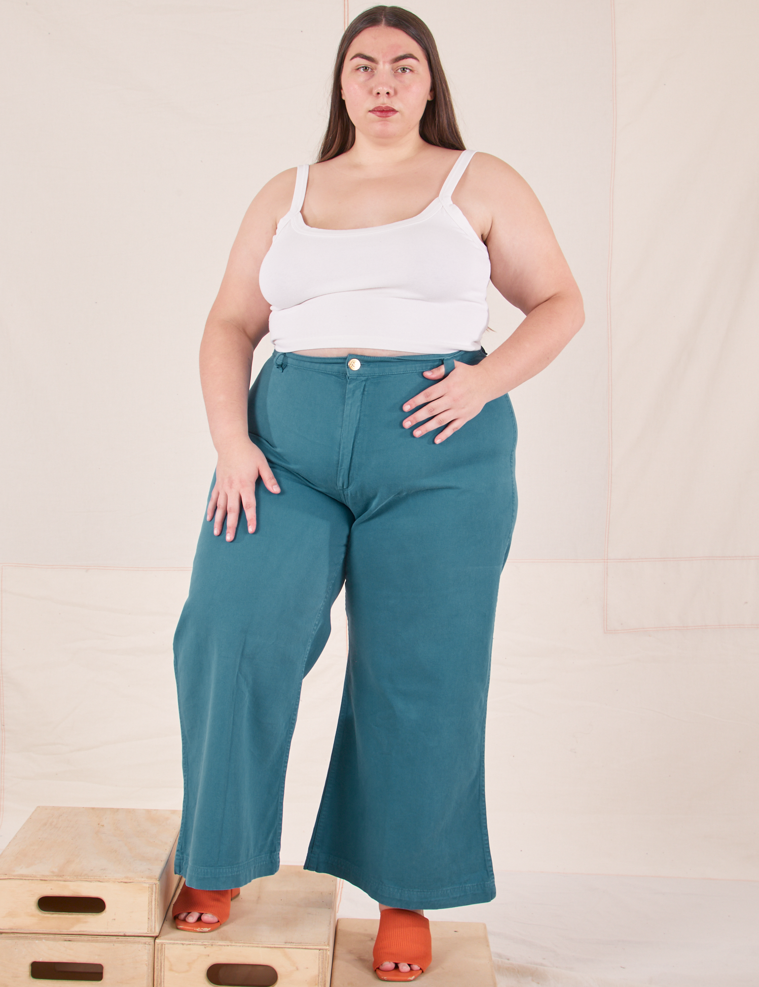 Marielena is 5&#39;8&quot; and wearing 2XL Bell Bottoms in Marine Blue paired with Cropped Cami in vintage tee off-white