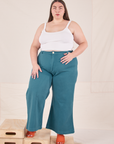 Marielena is 5'8" and wearing 2XL Bell Bottoms in Marine Blue paired with Cropped Cami in vintage tee off-white