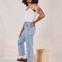 Side view of Carpenter Jeans in Light Wash worn by Jesse