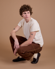 Carpenter Jeans in Fudgesicle Brown and the Organic Vintage Tee in Vintage Tee Off-White worn by Quinn