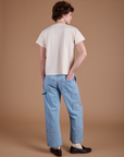 Back view of Carpenter Jeans in Light Wash and Organic Vintage Tee in Vintage Tee Off-White on Quinn