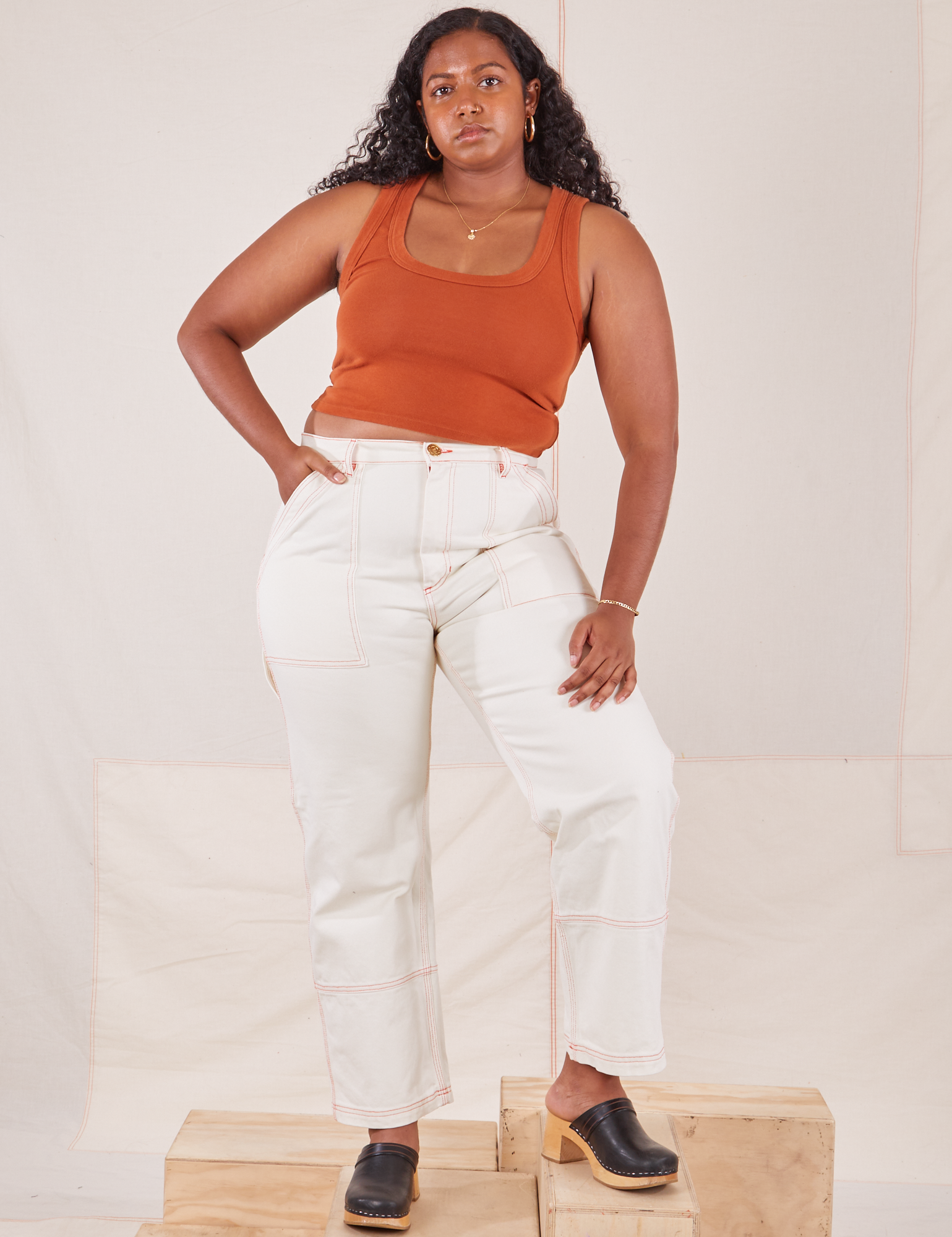 Meghna is 5&#39;8&quot; and wearing L Carpenter Jeans in Vintage Tee Off-White paired with burnt terracotta Cropped Tank Top