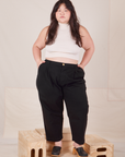 Ashley is 5'7" and wearing 1XL Petite Heavyweight Trousers in Basic Black paired with Sleeveless Turtleneck in vintage tee off-white 