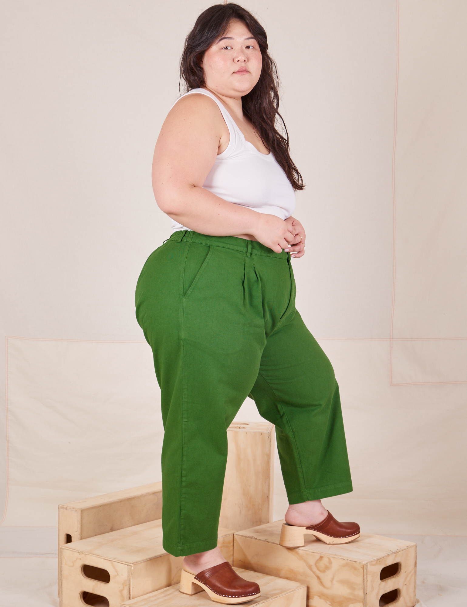 Side view of Heavyweight Trousers in Lawn Green and Cropped Tank Top in vintage tee off-white worn by Ashley