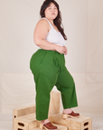 Side view of Heavyweight Trousers in Lawn Green and vintage off-white Cropped Cami worn by Ashley