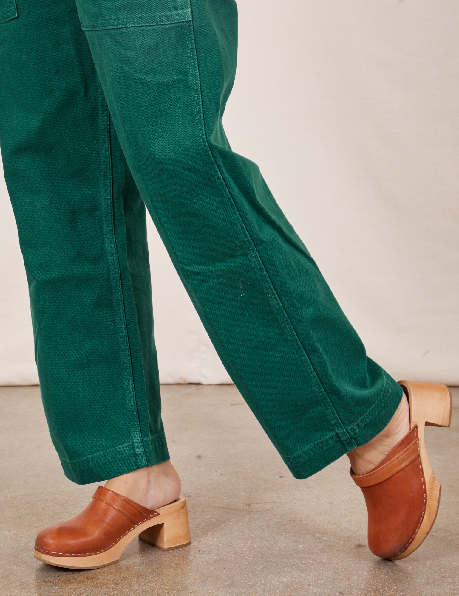 Pant leg close up of Original Overalls in Mono Hunter Green worn by Tiara