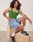 Jesse is wearing Carpenter Shorts in Light Wash and lawn green Cropped Tank