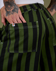 Close up of Jesse's hand in the back pocket of Longline Work Shorts in Evergreen