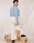 Angled back view of Long Sleeve V-Neck Tee in Periwinkle and vintage tee off-white Western Pants on Miguel