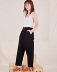 Side view of Denim Trouser Jeans in Black and Cropped Tank Top in vintage tee off-white on Hana