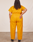 Back view of Short Sleeve Jumpsuit in Mustard Yellow worn by Alicia