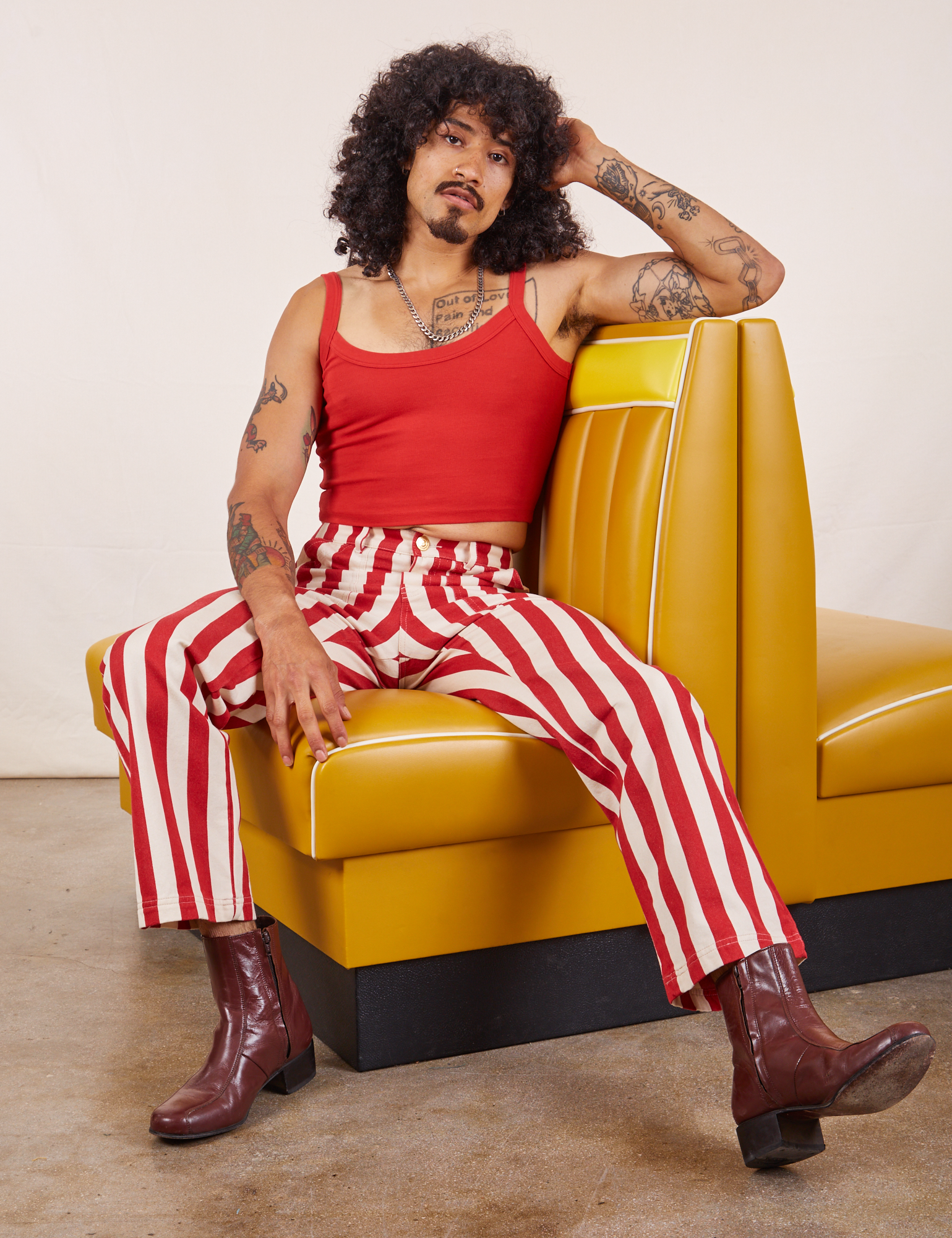 Jesse is wearing Work Pants in Cherry Stripe and mustang red Cropped Cami