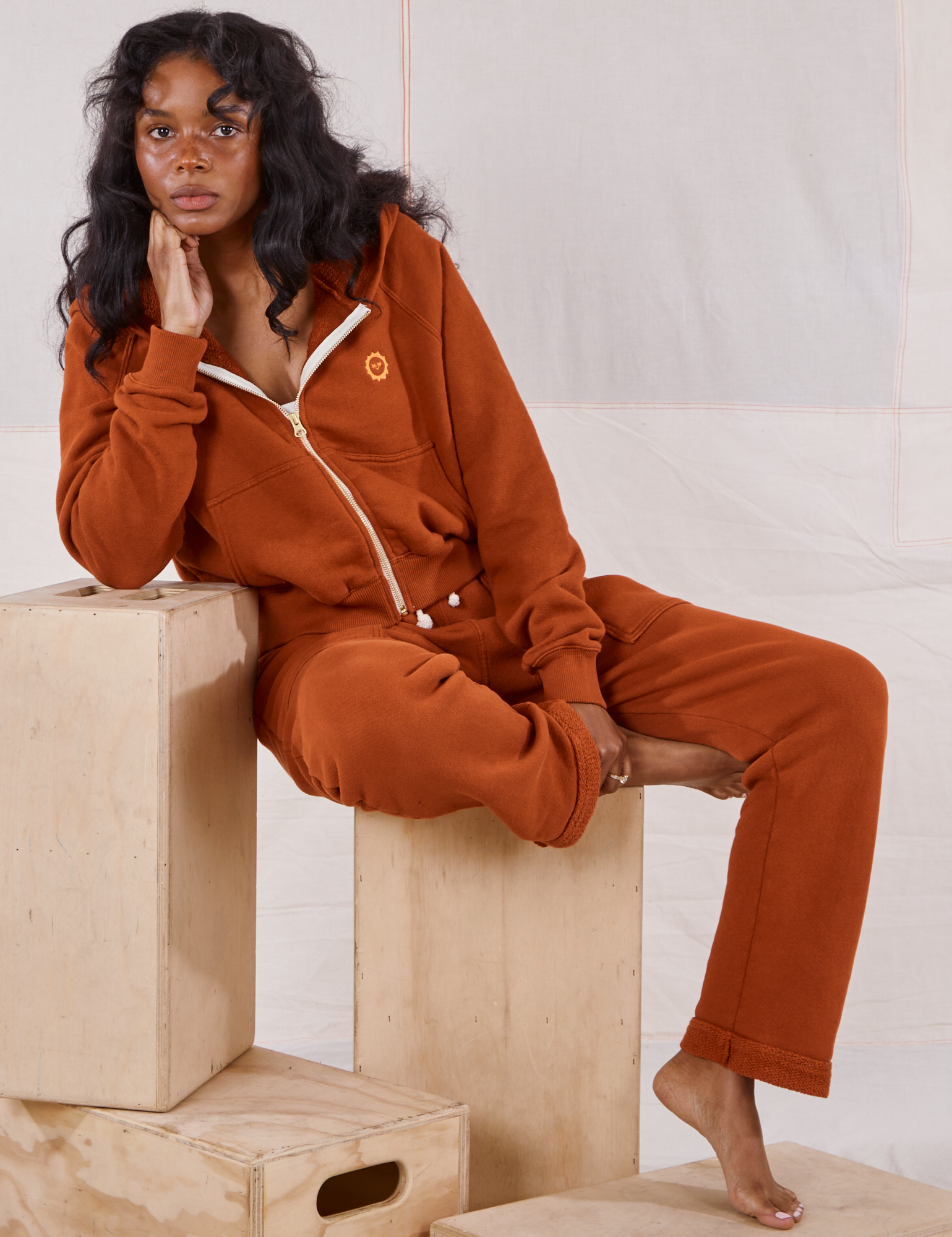 Kandia is wearing Rolled Cuff Sweat Pants in Burnt Terracotta and matching Cropped Zip Hoodies