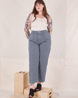 Sydney is wearing Denim Trouser Jeans in Railroad Stripe and a vintage off-white Tank Top