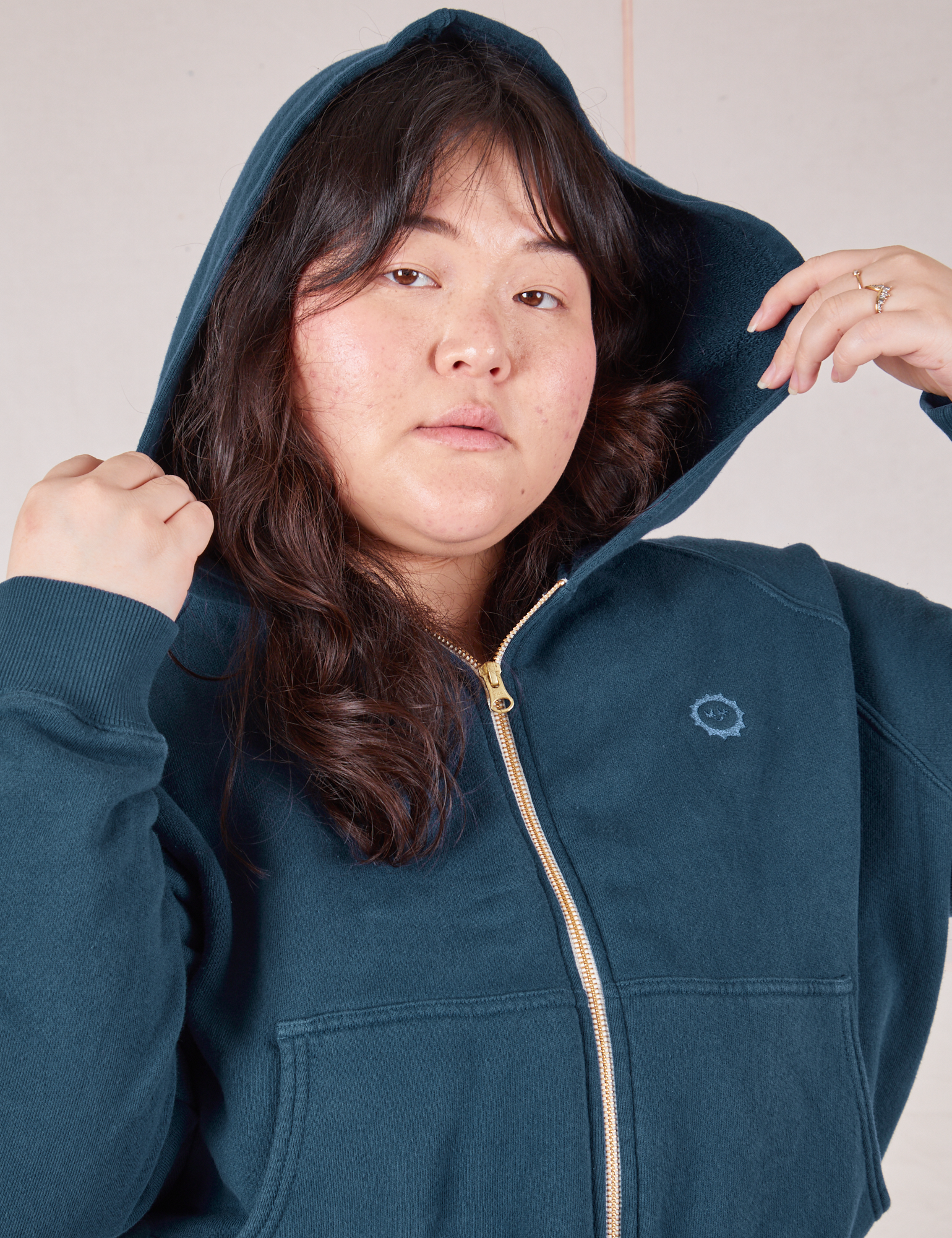 Close up of Cropped Zip Hoodie in Lagoon on Ashley with hood up