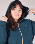 Close up of Cropped Zip Hoodie in Lagoon on Ashley with hood up