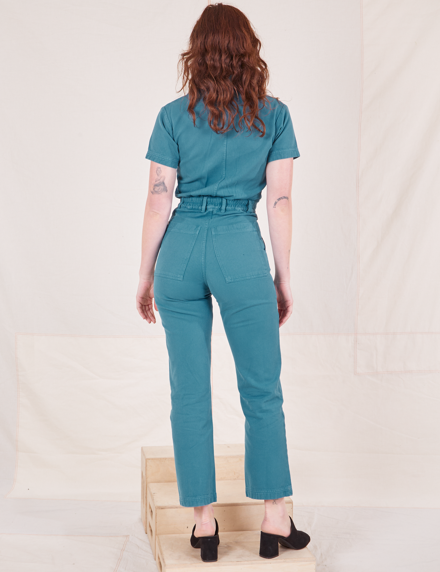 Heritage Short Sleeve Jumpsuit in Marine Blue back view on Alex