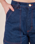 Carpenter Shorts in Dark Wash front pocket close up. Margaret has her hand in the pocket.