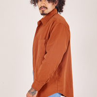 Side view of Oversize Overshirt in Burnt Terracotta worn by Jesse