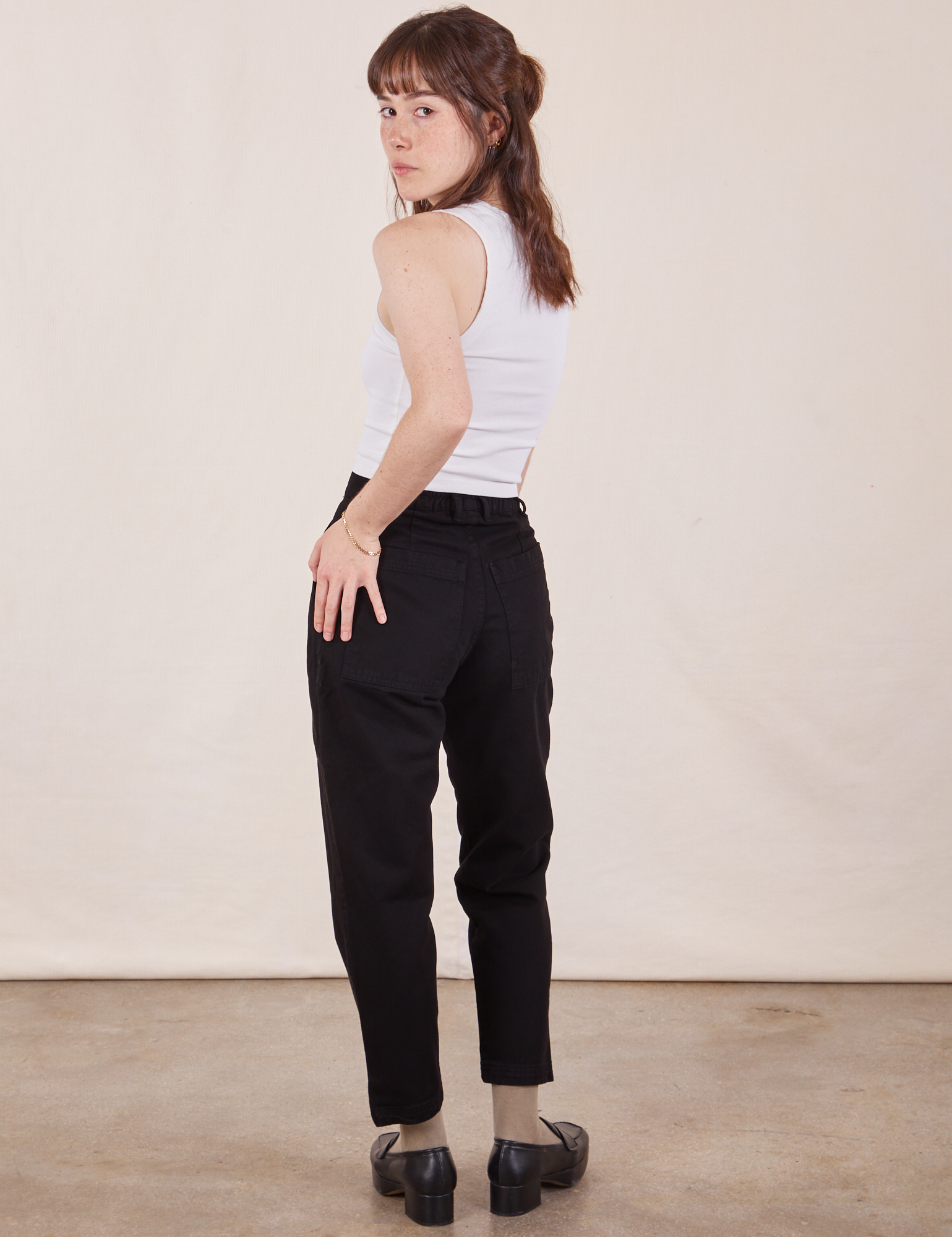 Back view of Petite Pencil Pants in Basic Black and vintage off-white Cropped Tank Top on Hana