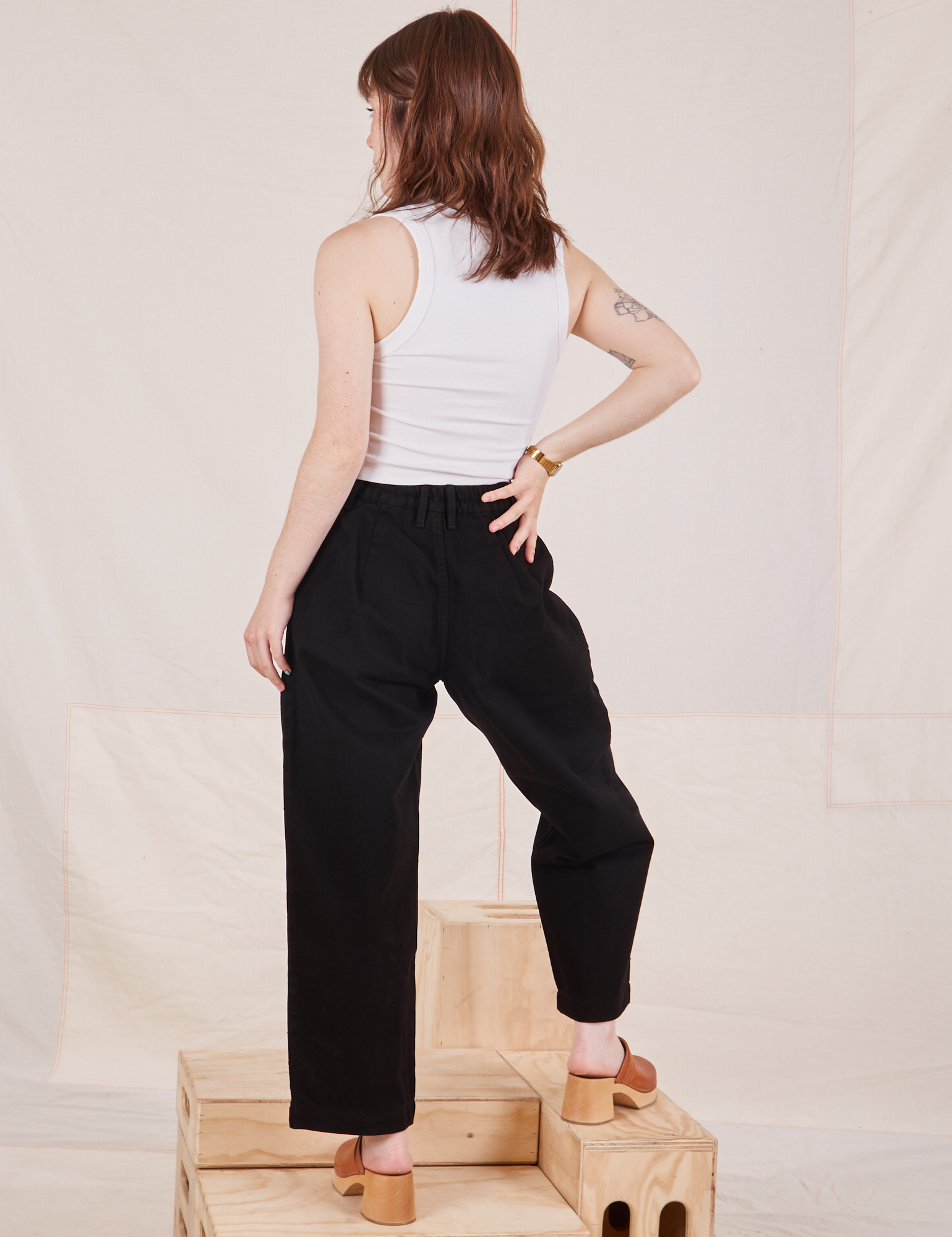 Back view of Denim Trouser Jeans in Black with Cropped Tank Top in vintage tee off-white on Hana