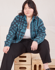 Ashley is wearing Plaid Flannel Overshirt in Marine Blue and black Work Pants