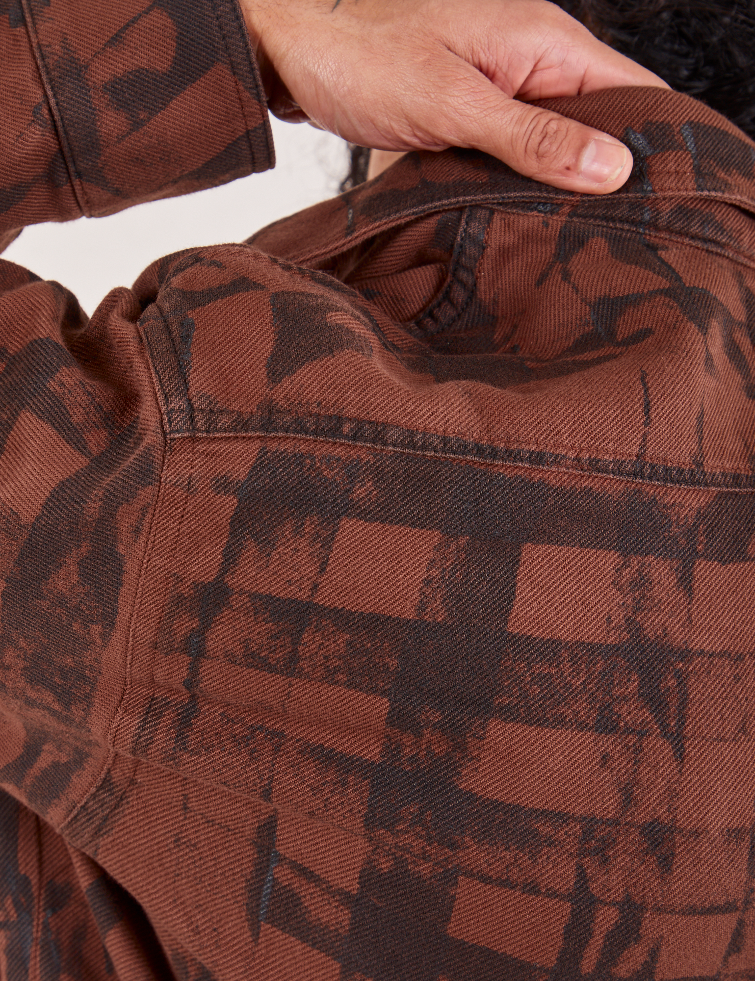 Plaid Flannel Overshirt in Fudgesicle Brown back shoulder close up on Jesse
