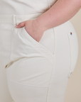 Close up of Ashley's hand in the front pocket of Short Sleeve Jumpsuit in Vintage Tee White