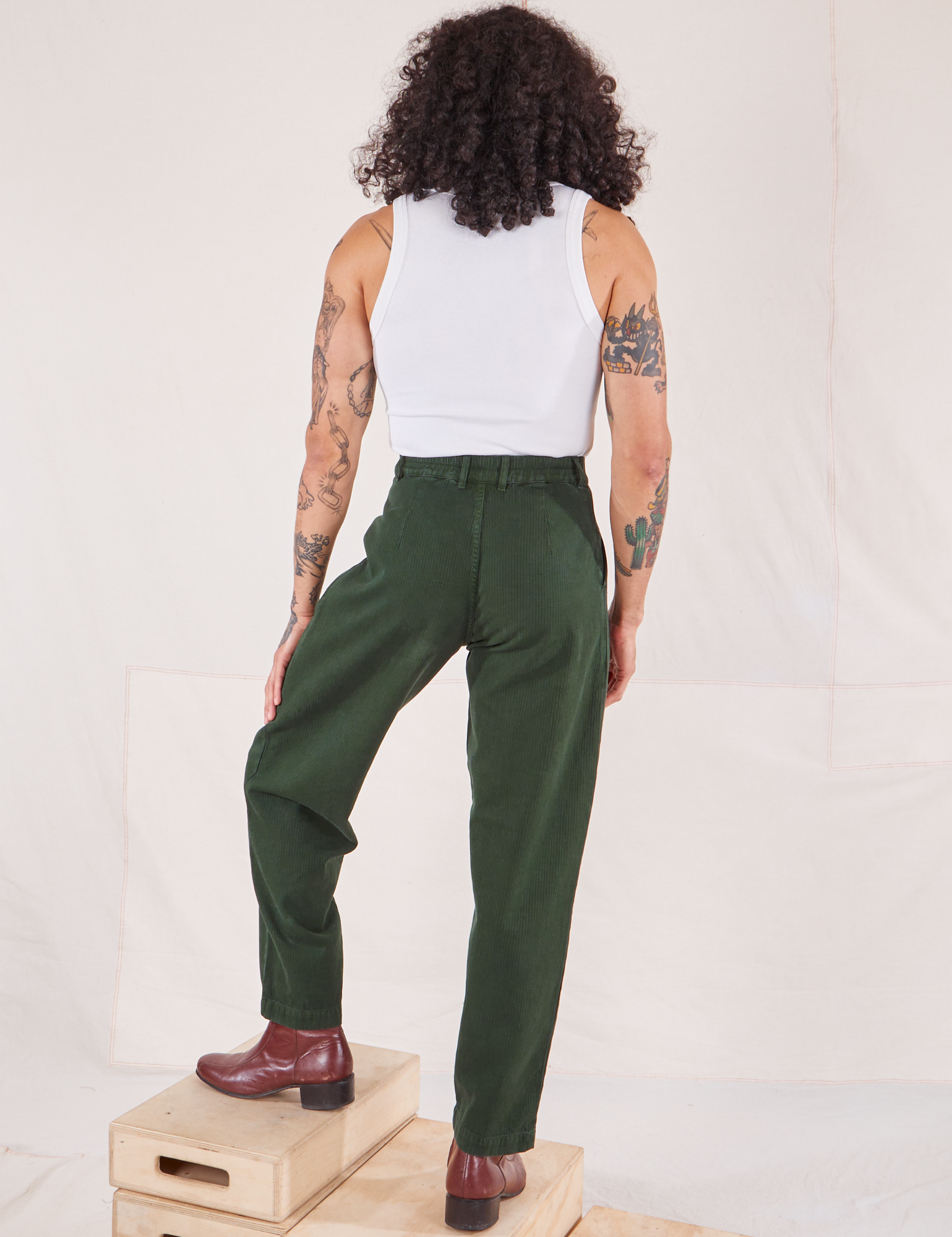 Back view of Heritage Trousers in Swamp Green and Cropped Tank Top in vintage tee off-white