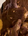 Close up of Demi's hand in the back pocket of Magic Waters Drop Pocket Pants in Honey Brown