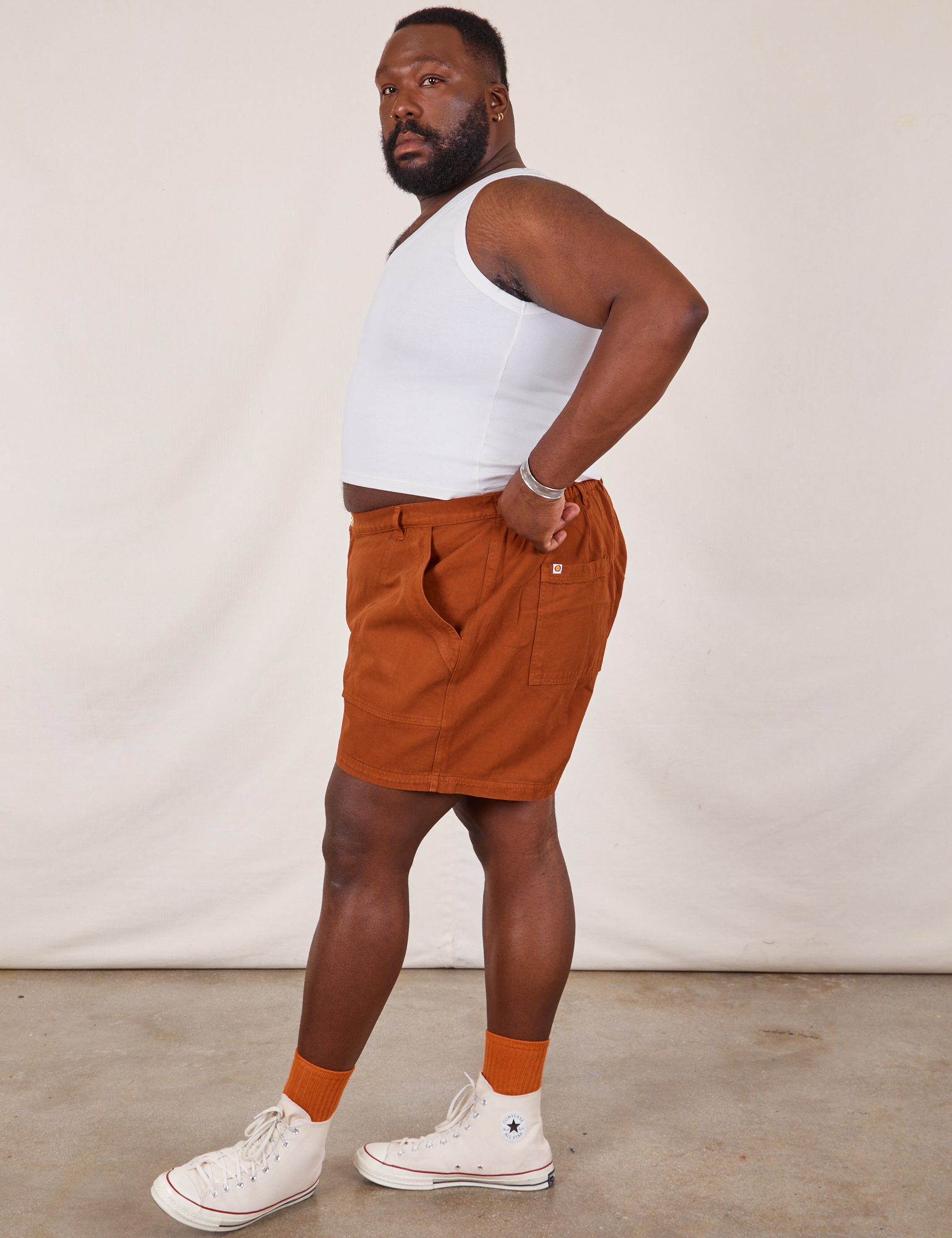 Side view of Classic Work Shorts in Burnt Terracotta and Cropped Tank Top in vintage tee off-white on Elijah