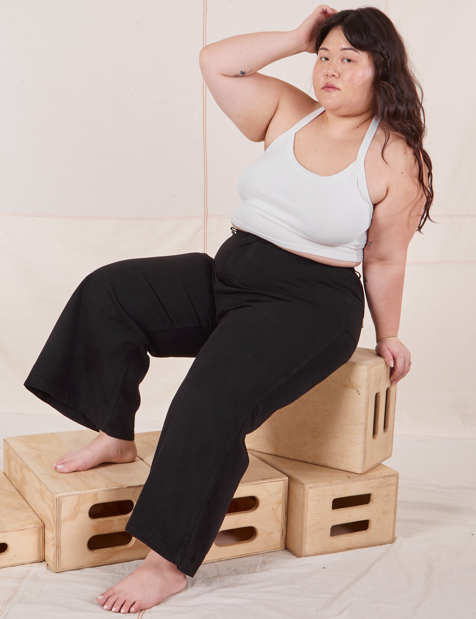 Ashley is wearing Petite Bell Bottoms in Basic Black and vintage off-white Halter Top.