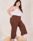 Side view of Petite Bell Bottoms in Fudgesicle Brown and Halter Top in vintage tee off-white on Ashley