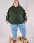 Catie is 5'11" and wearing 5XL Flannel Overshirt in Swamp Green paired with light wash Trouser Jeans