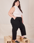 Side view of Heavyweight Trousers in Basic Black and Sleeveless Turtleneck in vintage tee off-white worn by Ashley.